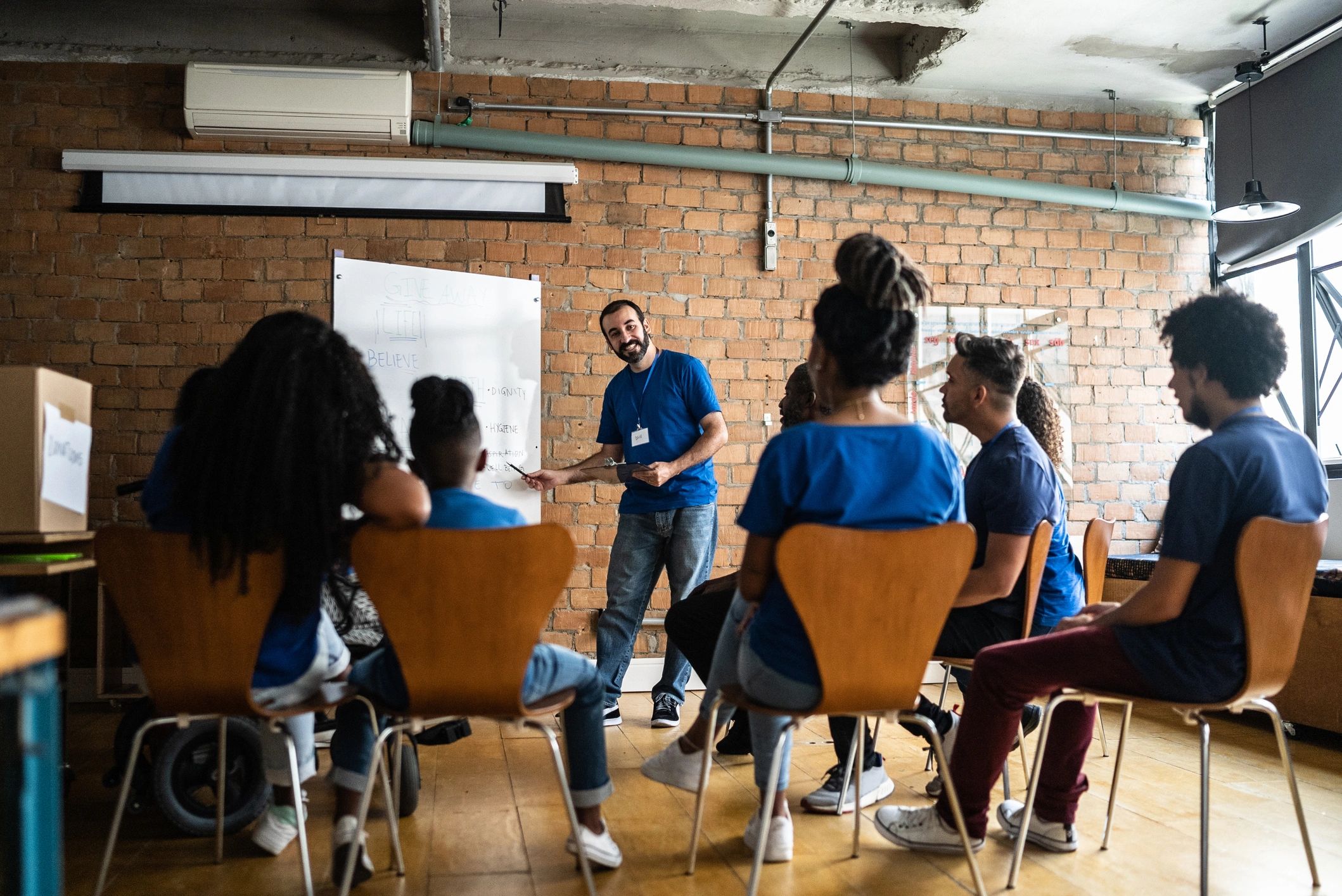 Community member speaking during a support meeting at a community center