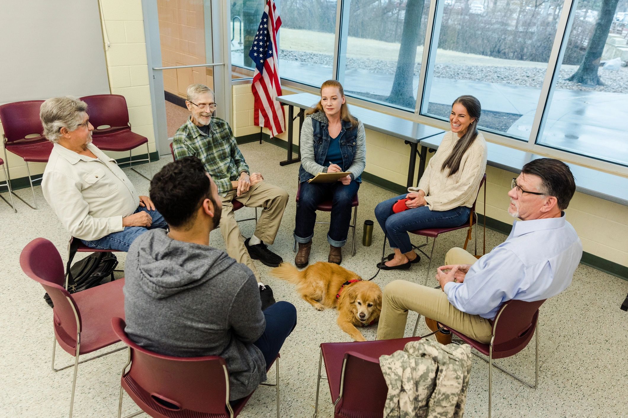 Multigenerational group of veterans meeting together in a support circle