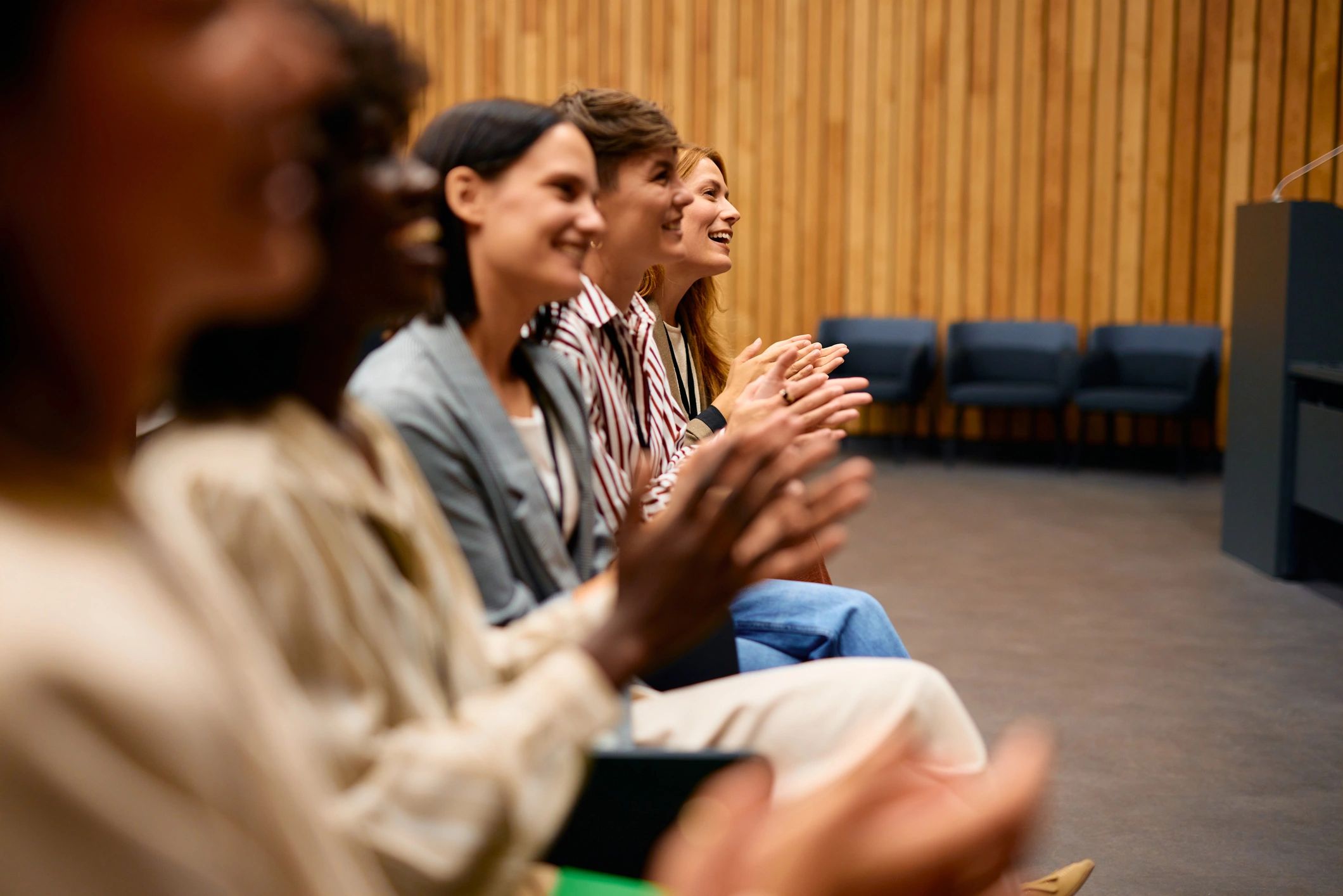 Community audience applauding at an event