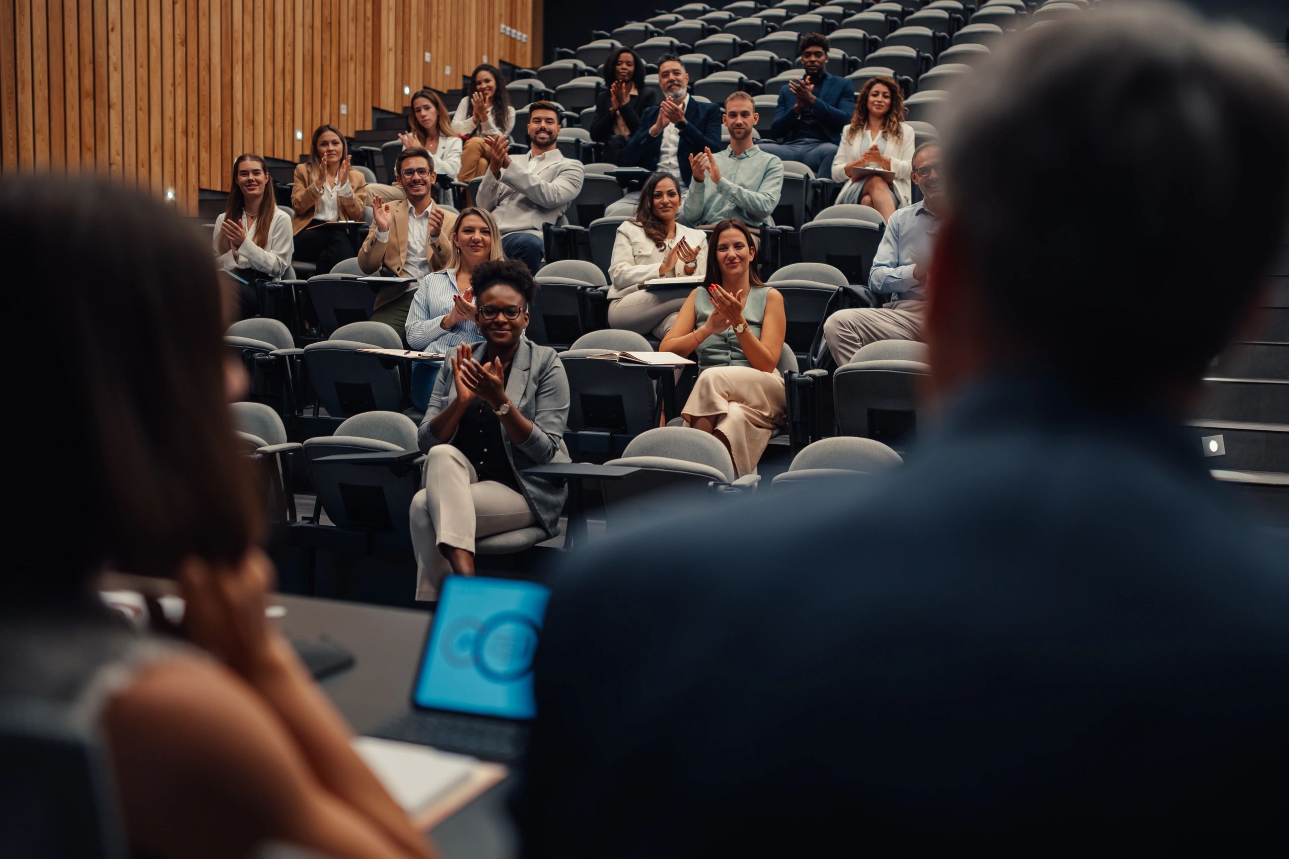 Community partners applauding at a conference event